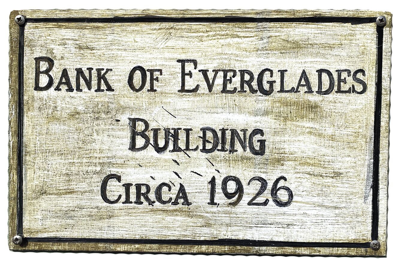 6. This sign hangs on the side of the bank building. adjust.tif